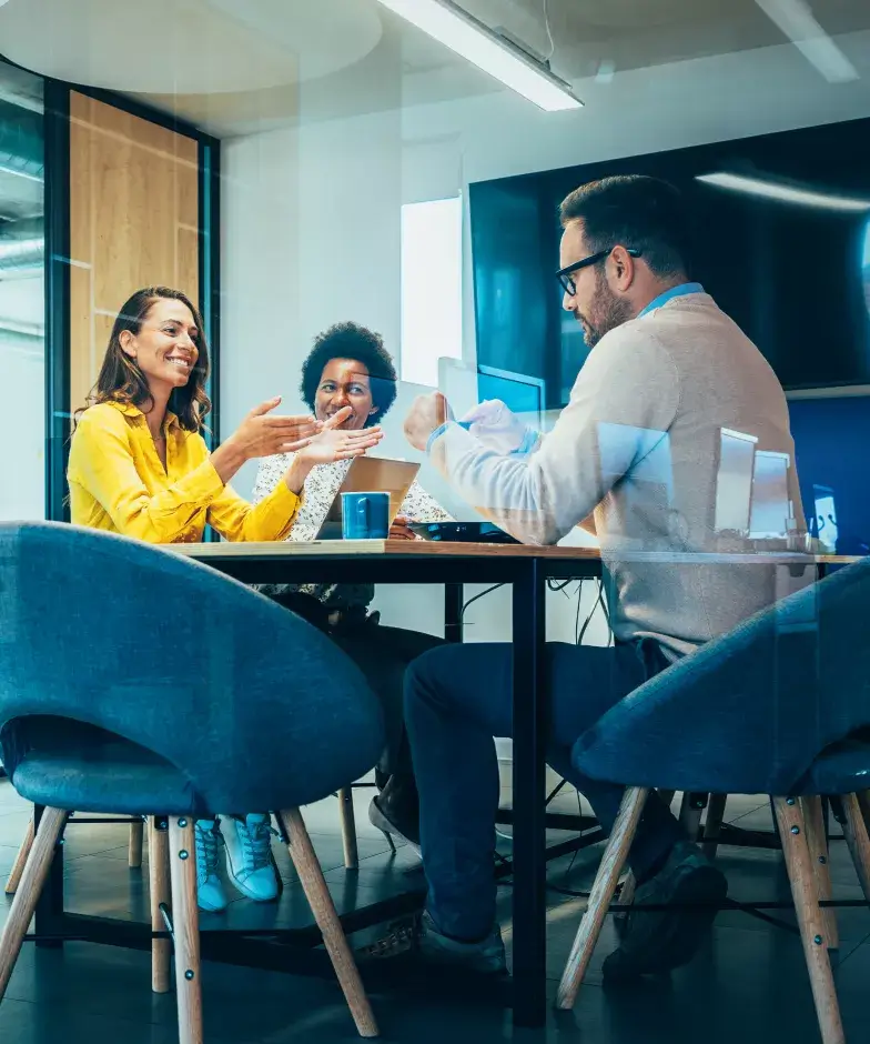 A group of three individuals having a conversation in a meeting. Learn more about Stifel Venture & Private Equity Sponsored Fund Banking.