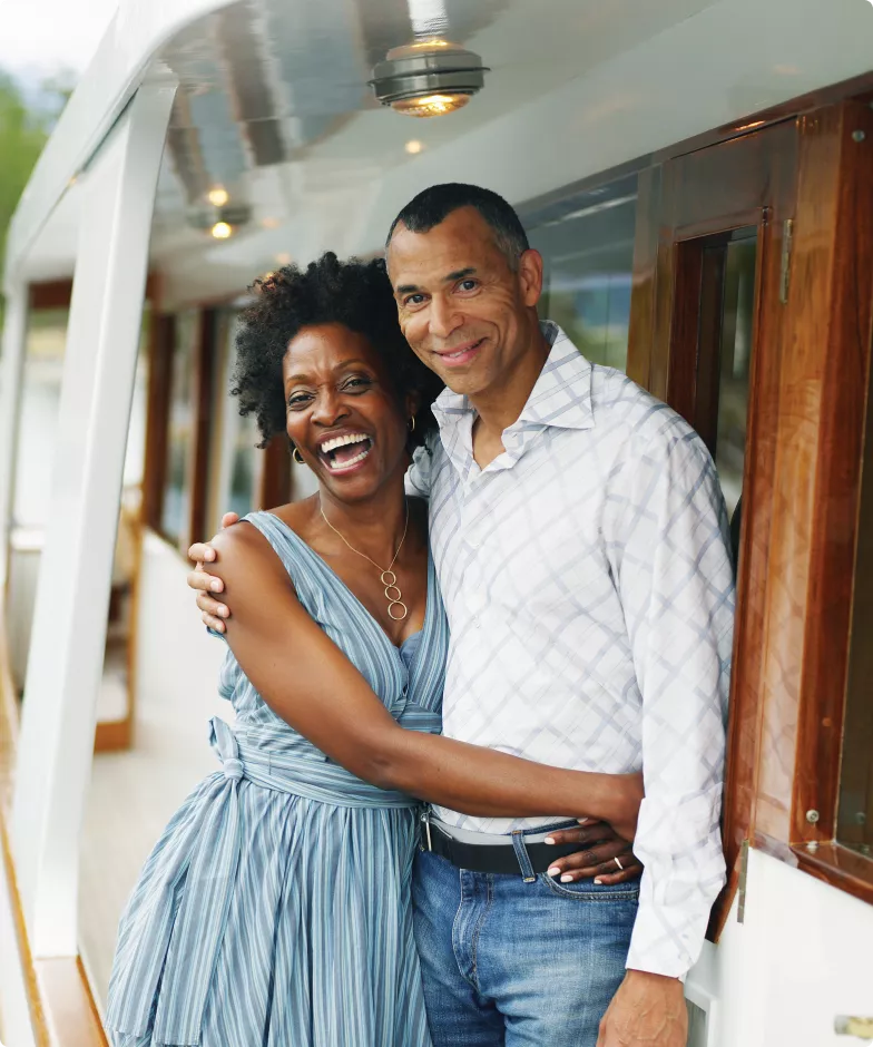 A happy couple hugging and laughing. Learn more about Stifel Private Client Lending Liquidity Solutions.