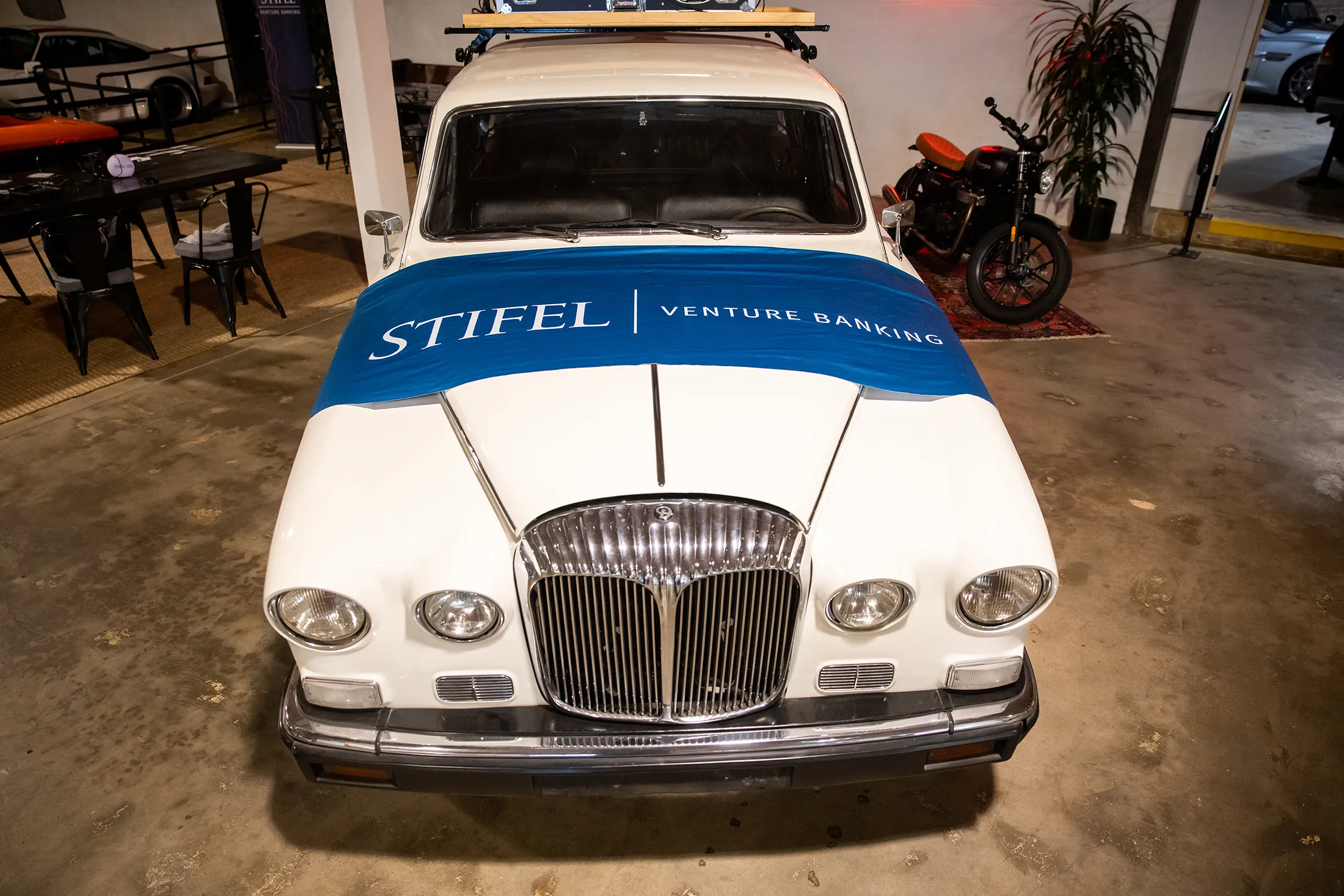 Stifel Venture Banking Banner draped across vintage car